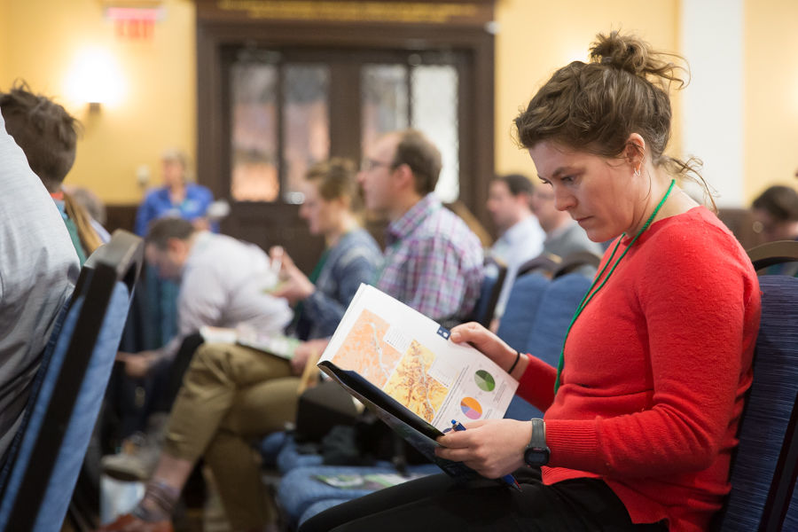 Katie Harris, Capital Trails Coalition coordinator at Washington Area Bicyclist Association, peruses the new impact report.